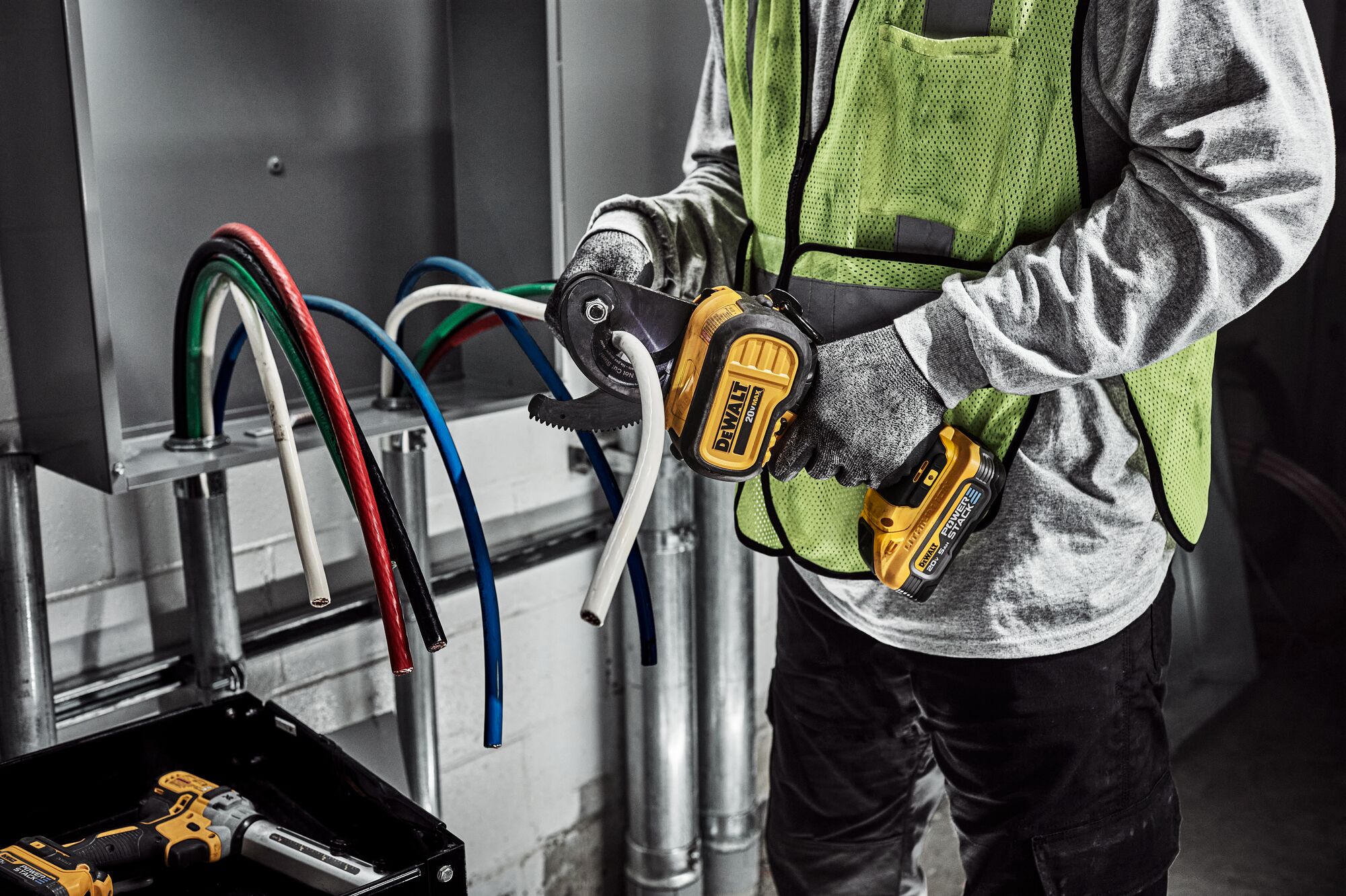 DEWALT Cable Cutter is used to cute cable to length by a tradesman in a electrical room.