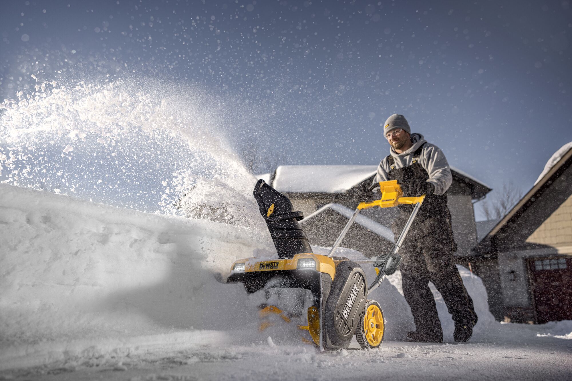 DEWALT Single-Stage Snow Blower application image person blowing snow front angle